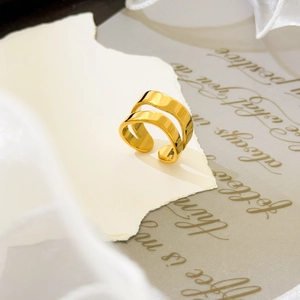 Detail of 18K gold-plated double-layer spiral open ring on vintage aesthetic background