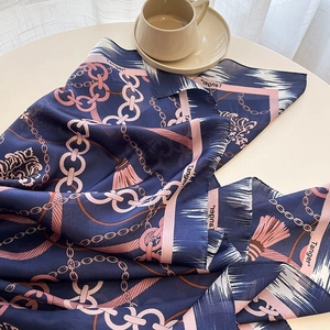Detail of silk-feel scarf with navy blue chain print and high-quality hemmed edges