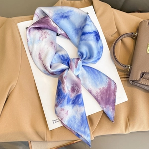 Silk neck scarf with blue and purple gradient tie-dye pattern on khaki blazer background