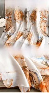 Detail of silk-feel scarf showing fine stitched edges and ink art pattern design