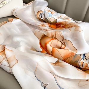 Lightweight silk shawl with abstract orange floral ink painting on white background