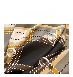 Detailed view of large square silk scarf featuring geometric lattice pattern and smooth texture