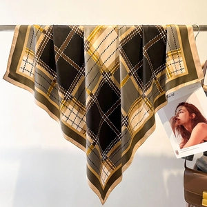 Classic British plaid silk square scarf draped on a metal bar with a vintage aesthetic