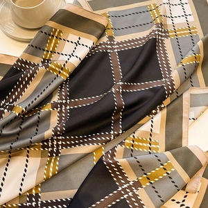 Detailed close-up of a large vintage plaid silk scarf with elegant drape and texture