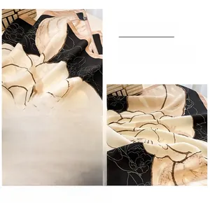 Detail shot of the elegant floral print silk scarf featuring premium hand-rolled edges