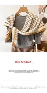 Detail of 90cm twill silk scarf with gold chain patterns on a grey knit top