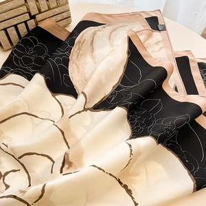 Detail of vintage floral pattern on soft square silk scarf with cream border