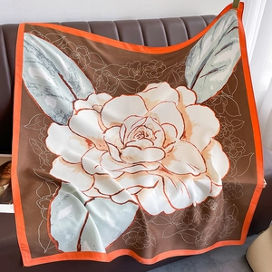 Detailed texture of a large square silk scarf with vintage camellia floral print
