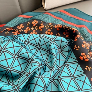 Elegant teal silk scarf with geometric prints and vintage floral border detail
