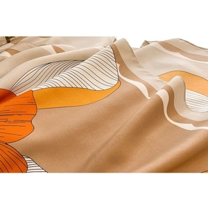 Satin silk scarf with abstract geometric print in orange and beige tones