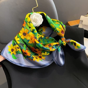 Luxurious silk scarf with yellow sunflowers and green leaves on an elegant grey-blue base
