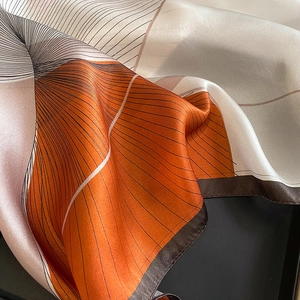 Elegant silk scarf featuring modern geometric lines in orange and brown tones