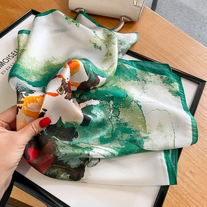 Artistic mulberry silk scarf featuring green and orange ink print with rolled edges