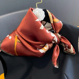 Elegant silk floral square scarf in deep red with botanical print and decorative brooch