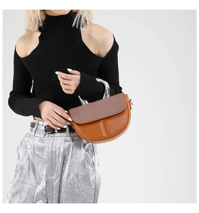 Fashionable brown leather saddle bag with silver handle and textured flap detail