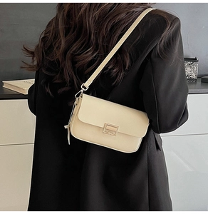 Chic cream white crossbody bag on black blazer showing back view and minimalist styling