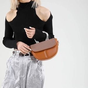 Contrast texture saddle bag with silver metal handle and brown patchwork leather design