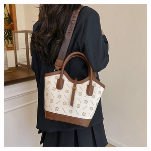 Detail of crossbody bag with clover print and detachable wide branded shoulder strap