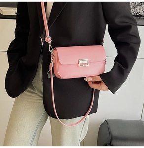 Close-up of pink rectangular leather crossbody bag with silver geometric metal buckle