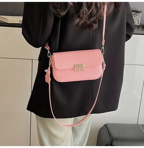 Detailed back view of a pink minimalist crossbody bag with adjustable leather strap