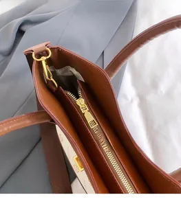 Detail of golden metal zipper and internal lining on a brown patterned tote bag
