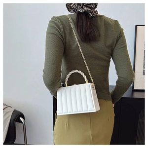 White structured handbag with vertical pleated design and golden chain strap for women