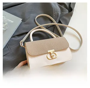 Detail of cream leather bag with luxury gold clasp and woven fabric flap texture