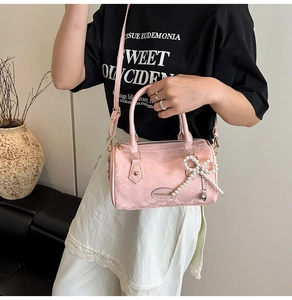 Pink snakeskin pattern Boston bag with pearl bow charm and adjustable shoulder strap