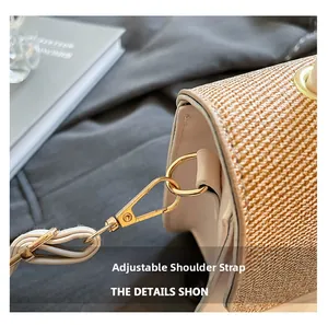 Detail of golden metal ring buckle and adjustable synthetic leather strap on woven bag