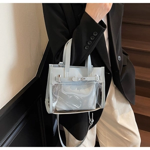 Dettaglio della borsa in PVC azzurro con chiusura metallica e cinturini in pelle