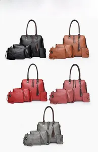 Detail of 4-piece tote bag set in litchi grain faux leather with tassel charm