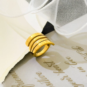 Macro shot of 18K gold-plated triple spiral ring with a high-polished mirror finish