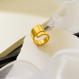 Detailed macro view of gold wide spiral bypass ring with 18K gold plated finish