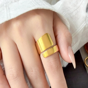 Detailed view of layered spiral 18K gold-plated wide ring with brushed metallic texture