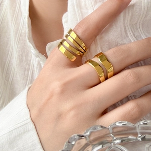 Double layer and spiral wide 18K gold plated titanium steel rings on model hand
