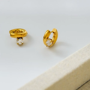 Macro view of gold plated hoop earrings with round cut cubic zirconia stones