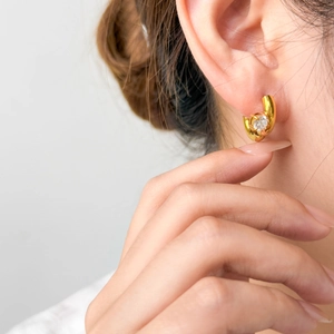 Macro view of a 18K gold-plated star earring with sparkling round cubic zirconia