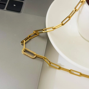 Detailed close-up of 18K gold plated oval chain necklace with a sparkling pave crystal link