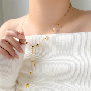Elegant 18K gold-plated Y-shaped necklace featuring white pearls and a round pendant