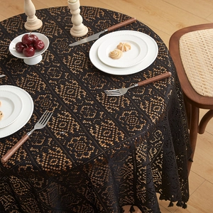 Retro black hollow crochet round tablecloth with elegant floral patterns and fringe