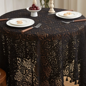 Detailed close-up of vintage black hollow lace tablecloth with intricate floral pattern