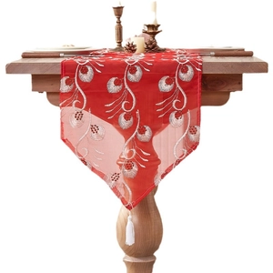 Chinese style red table runner with white embroidery and elegant white tassel on wood table