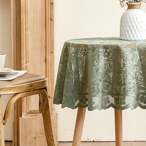 Close-up of vintage dark green floral lace tablecloth with elegant scalloped edges