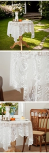Close-up of white sun flower lace tablecloth showing intricate embroidery and wavy edges