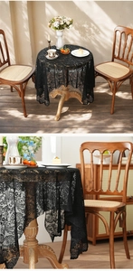 Close-up of black floral lace tablecloth featuring intricate hollow crochet and scalloped edges