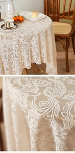Close-up of white floral lace tablecloth with paisley patterns and elegant scalloped edges