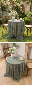 Detailed view of vintage lace tablecloth with elegant floral embroidery and ruffled edges