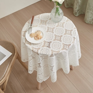 White round lace tablecloth with elegant openwork floral patterns for home decor