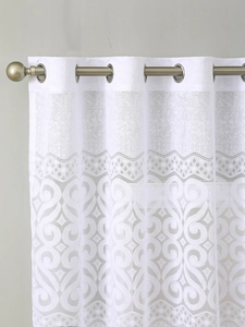 Detail view of white lace curtain with silver grommet top and elegant vine patterns
