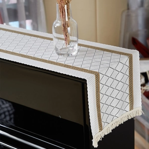 Linen piano cover cloth with black diamond pattern and decorative white fringe tassels